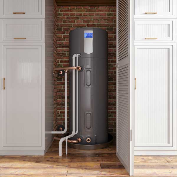 Modern water heater installed in a kitchen corner with exposed pipes.