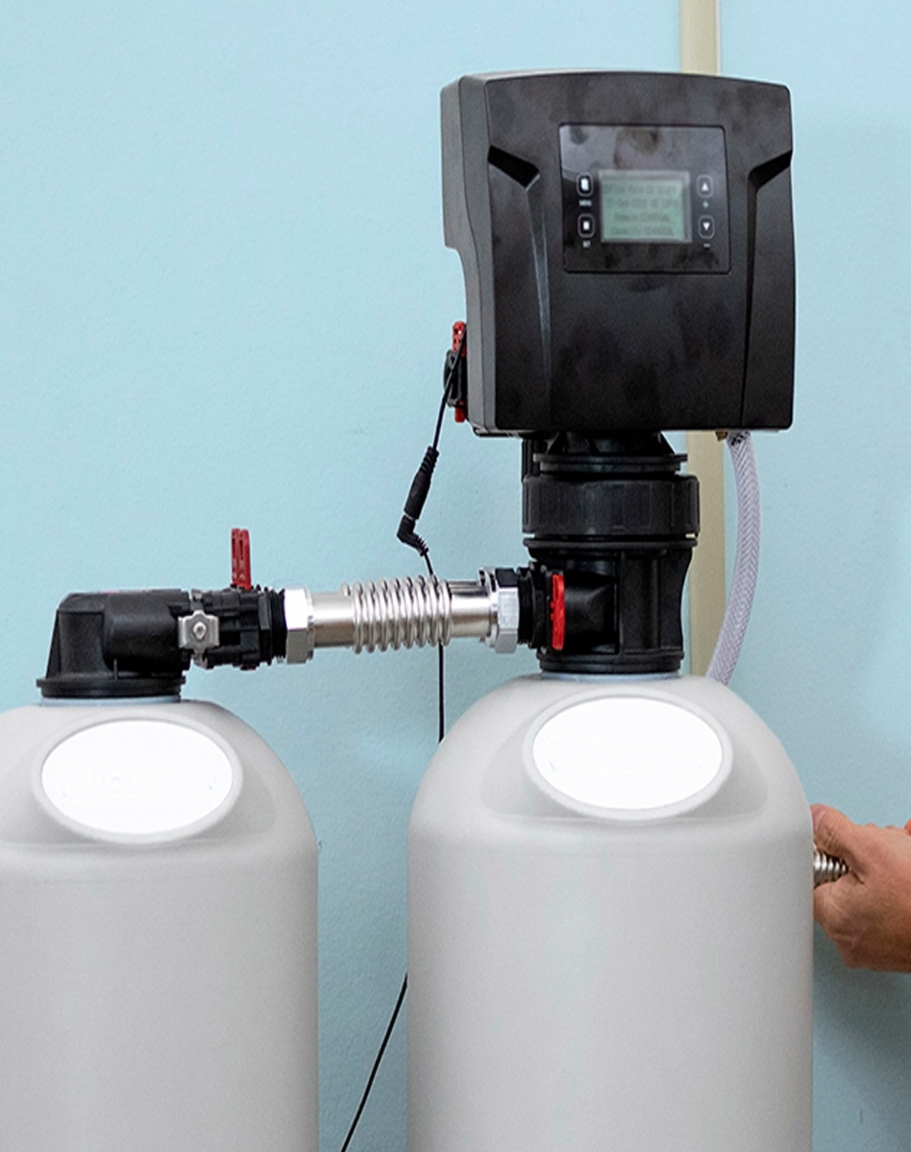 Water filtration system with two white tanks and a black control unit.